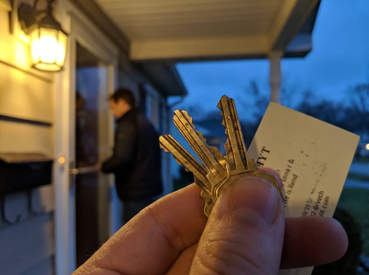 Technician handing over freshly cut keys after a lock service call